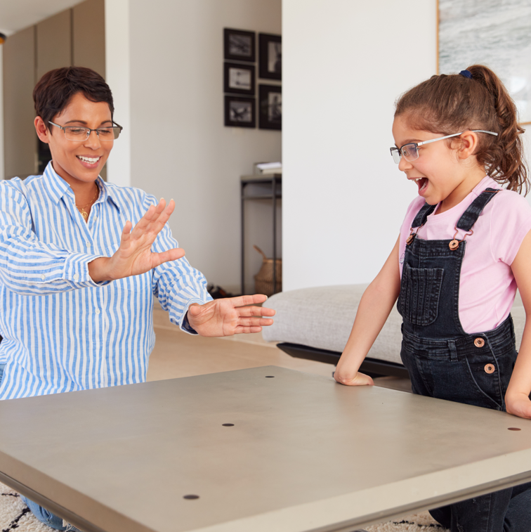 Happy woman and young girl looking at AR