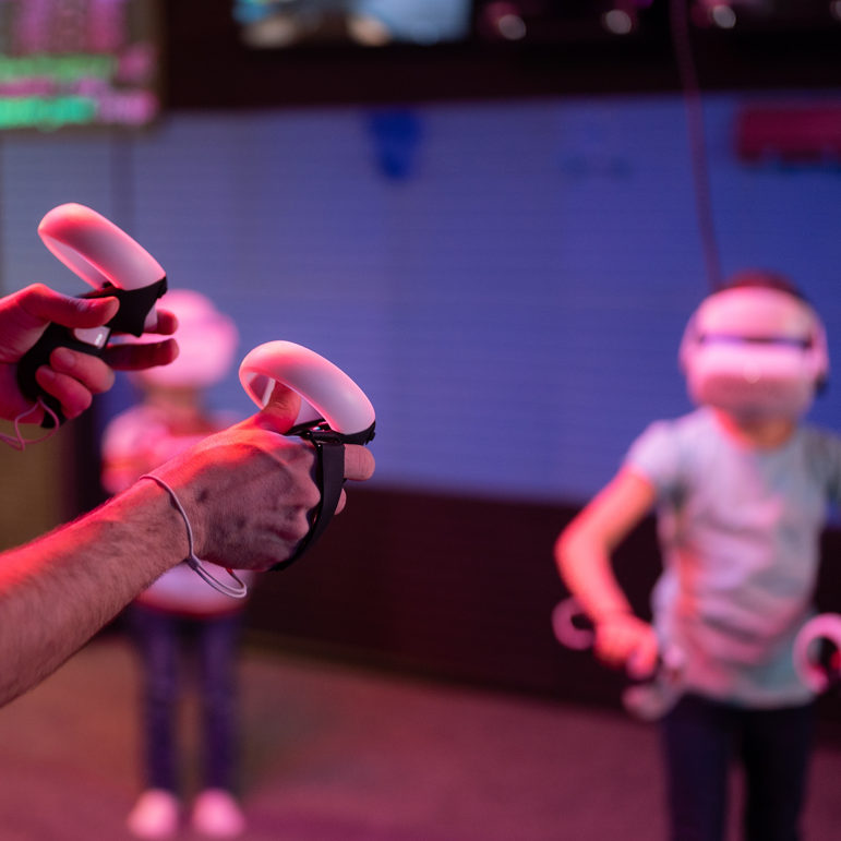 Teacher and two kids wearing VR headsets