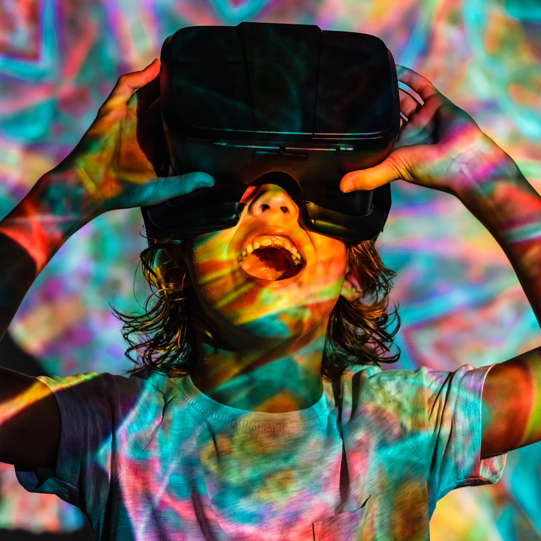 excited boy wearing virtual reality glasses